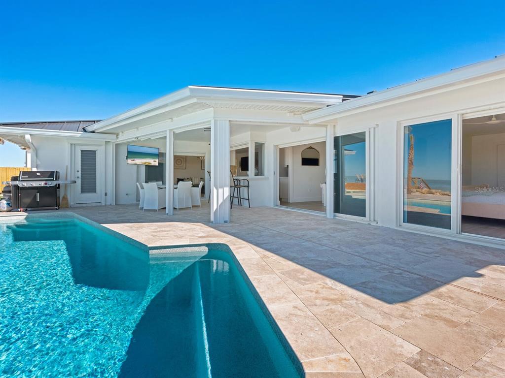 3743 Casey Key Road Nokomis, FL 34275 - Photo 14 of 36 a view of a house with swimming pool and porch