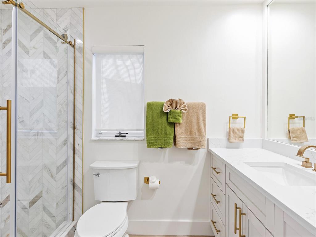 3743 Casey Key Road Nokomis, FL 34275 - Photo 15 of 36 a bathroom with a sink vanity mirror and toilet