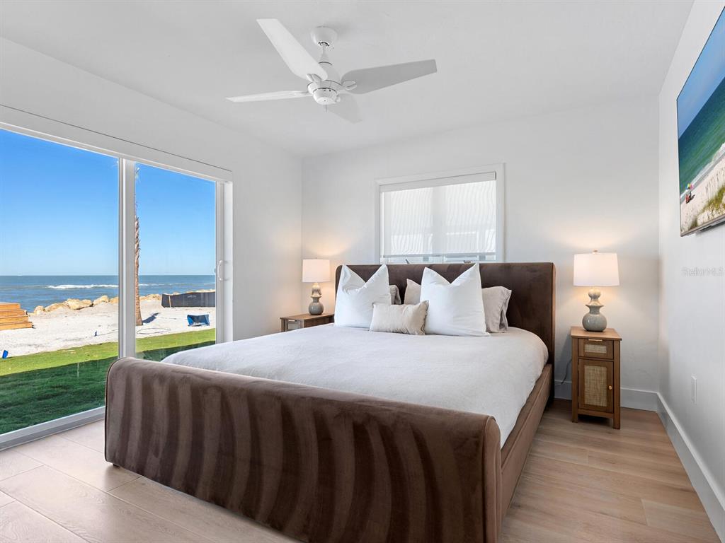 3743 Casey Key Road Nokomis, FL 34275 - Photo 16 of 36 a bedroom with a bed and a large window