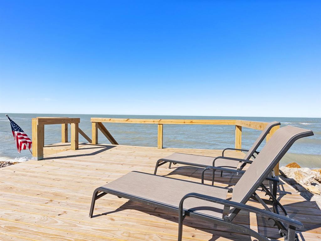 3743 Casey Key Road Nokomis, FL 34275 - Photo 19 of 36 a view of a swimming pool with a lounge chair