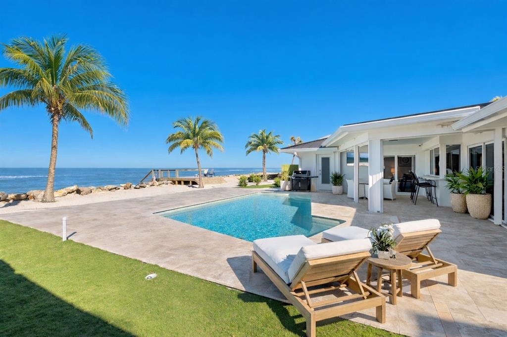 3743 Casey Key Road Nokomis, FL 34275 - Photo 2 of 36 a swimming pool with outdoor seating and yard