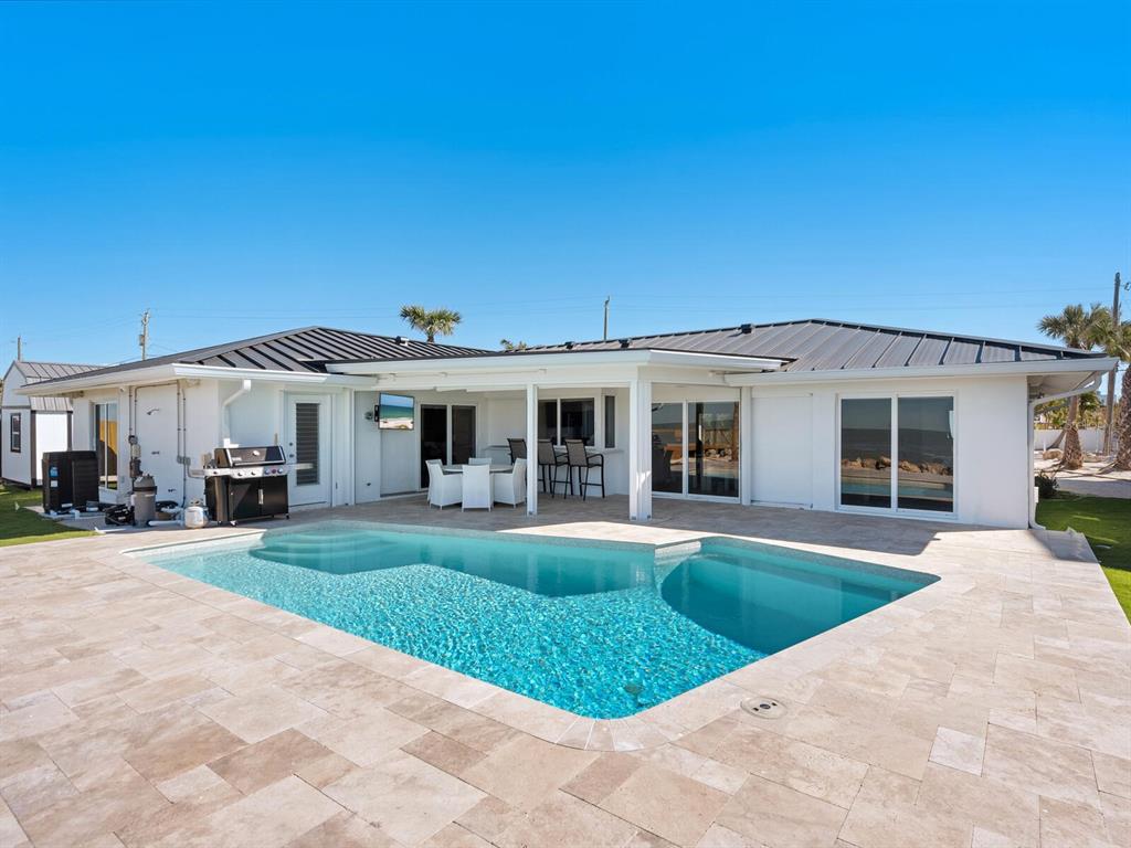 3743 Casey Key Road Nokomis, FL 34275 - Photo 22 of 36 a front view of a house with swimming pool and furniture