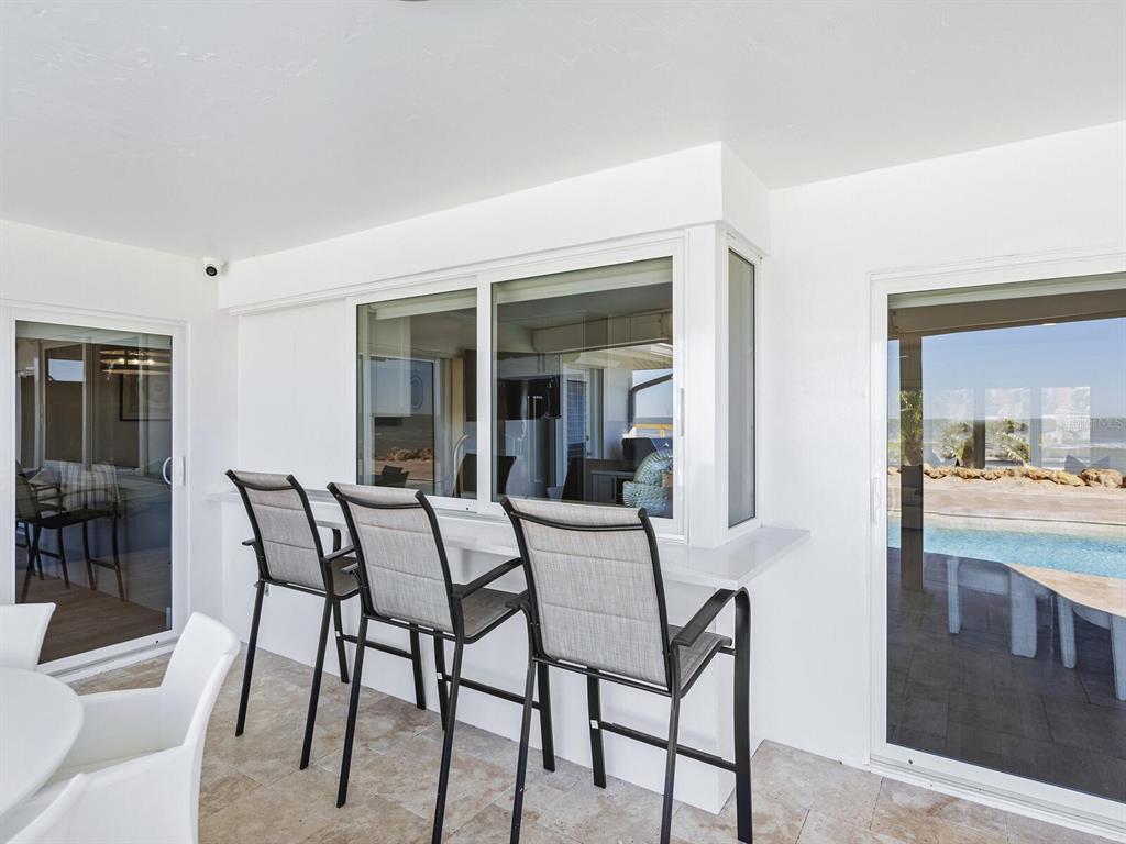 3743 Casey Key Road Nokomis, FL 34275 - Photo 23 of 36 a dining room with furniture and window