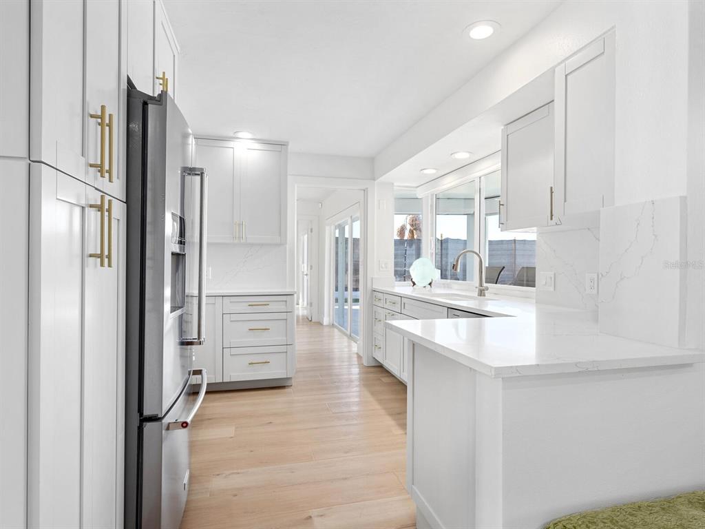 3743 Casey Key Road Nokomis, FL 34275 - Photo 26 of 36 a kitchen with refrigerator and cabinets