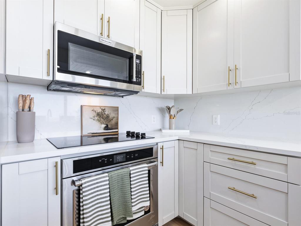 3743 Casey Key Road Nokomis, FL 34275 - Photo 9 of 36 a kitchen with stainless steel appliances white cabinets and a sink