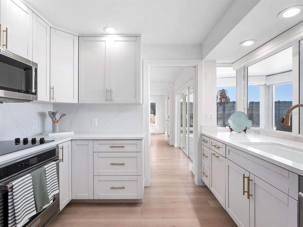 3743 Casey Key Road Nokomis, FL 34275 - Photo 10 of 36 a kitchen with stainless steel appliances white cabinets and a sink