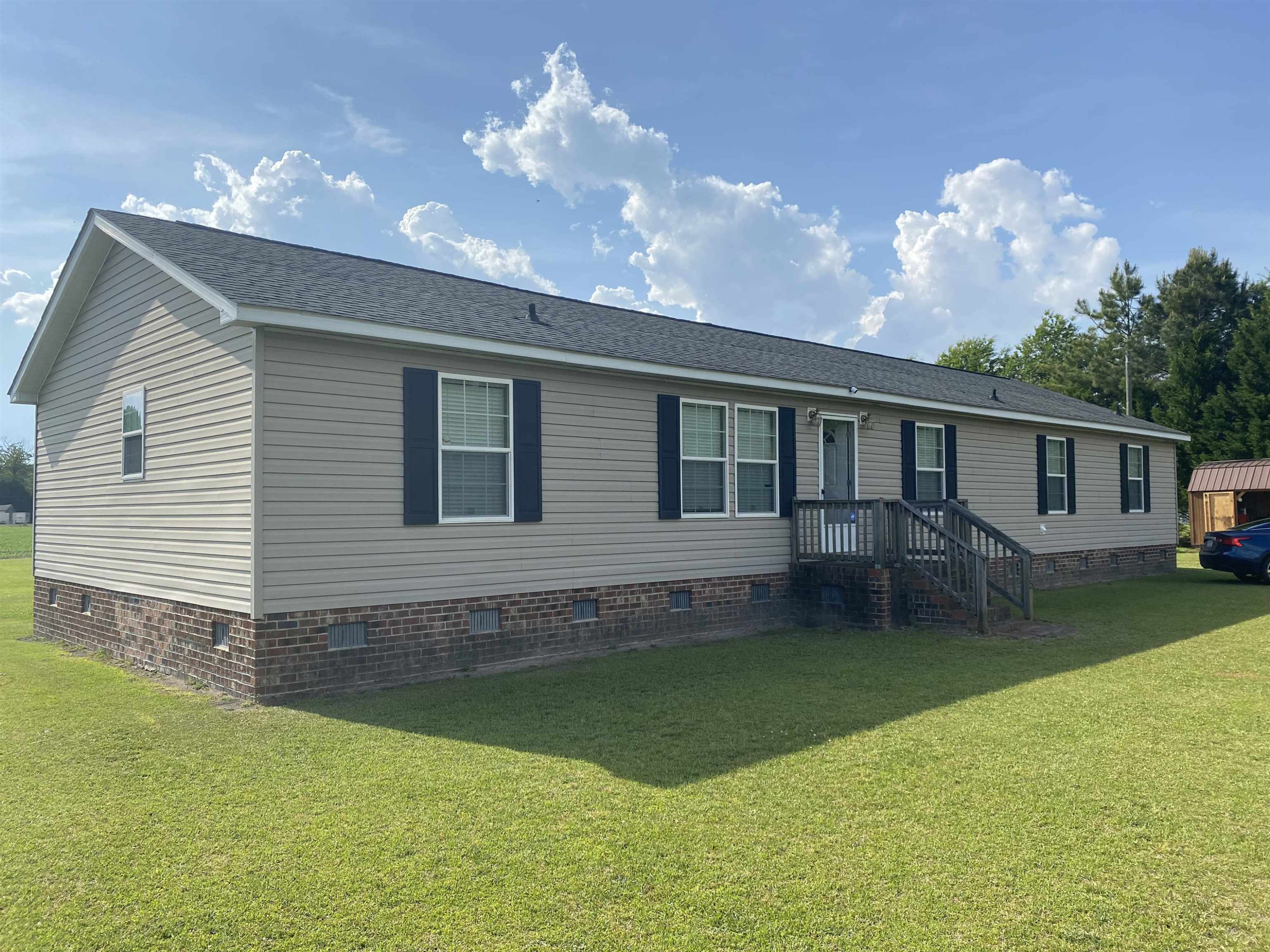 a backyard of a house with table and chairs