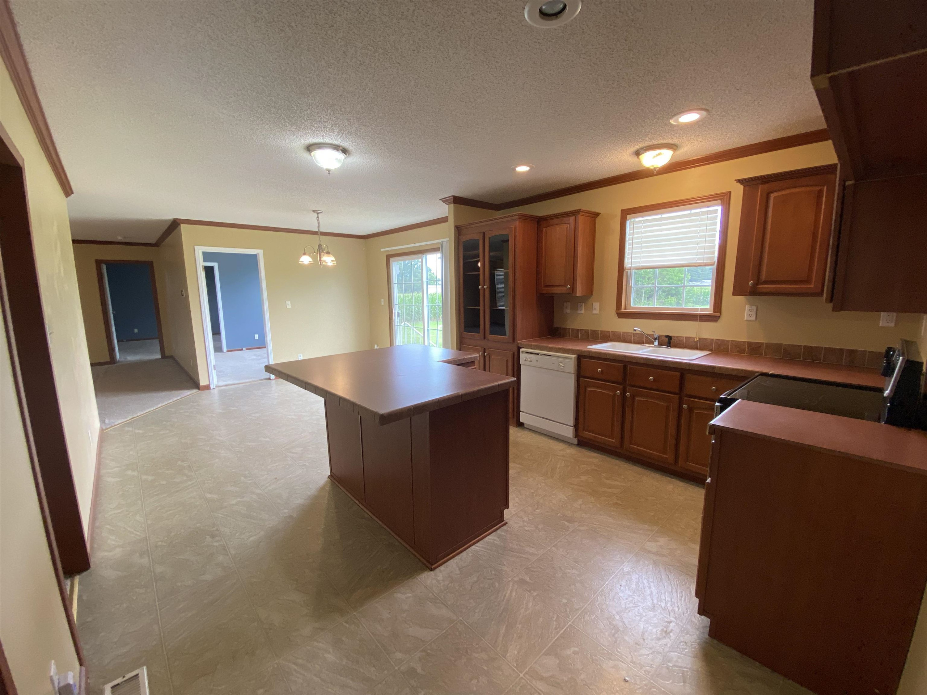 115 Bridgers Road Kenly, NC 27542 - Photo 12 of 30 a large kitchen with stainless steel appliances granite countertop a sink and a stove