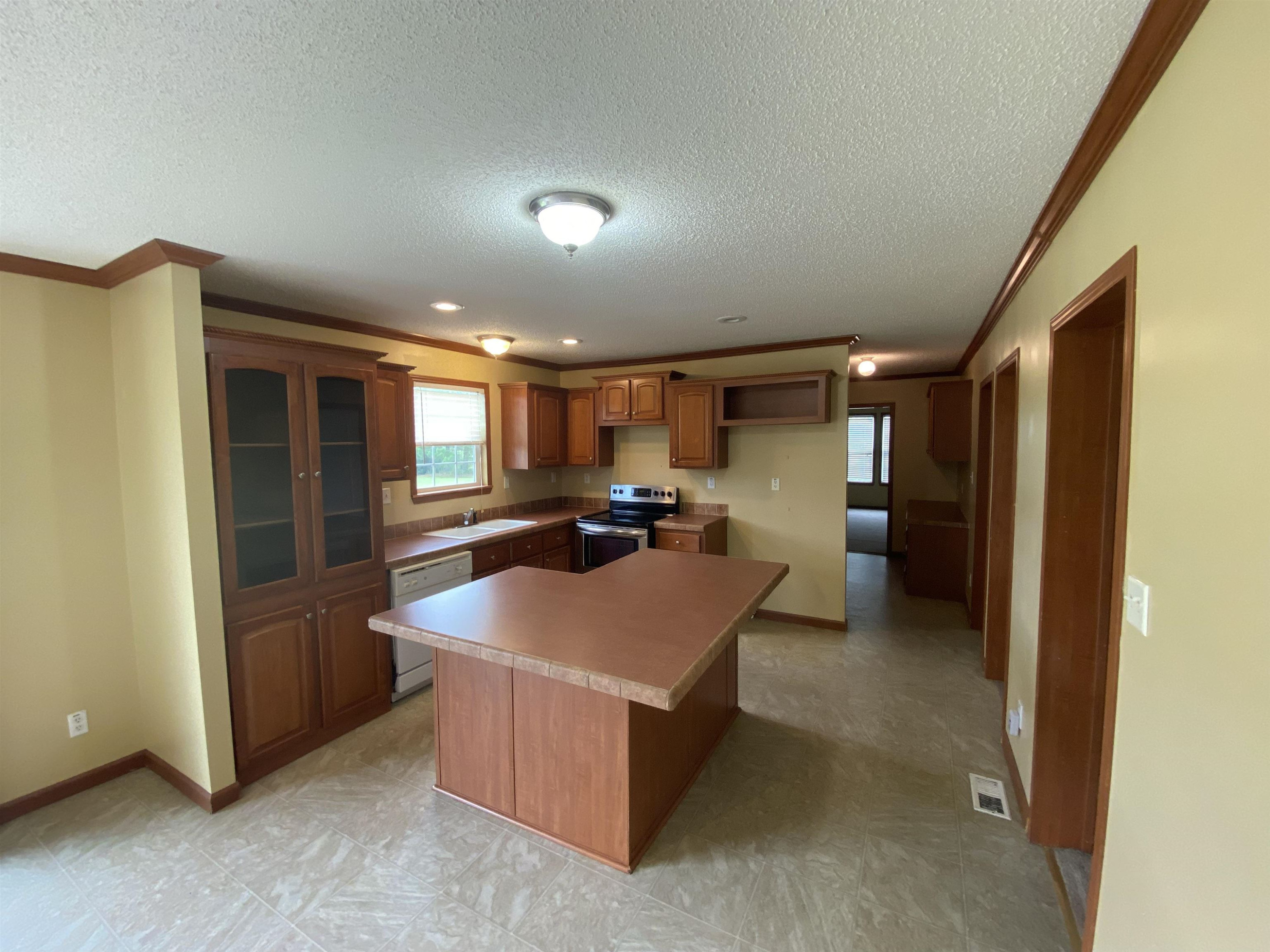 115 Bridgers Road Kenly, NC 27542 - Photo 14 of 30 a large kitchen with a large counter top stainless steel appliances and cabinets