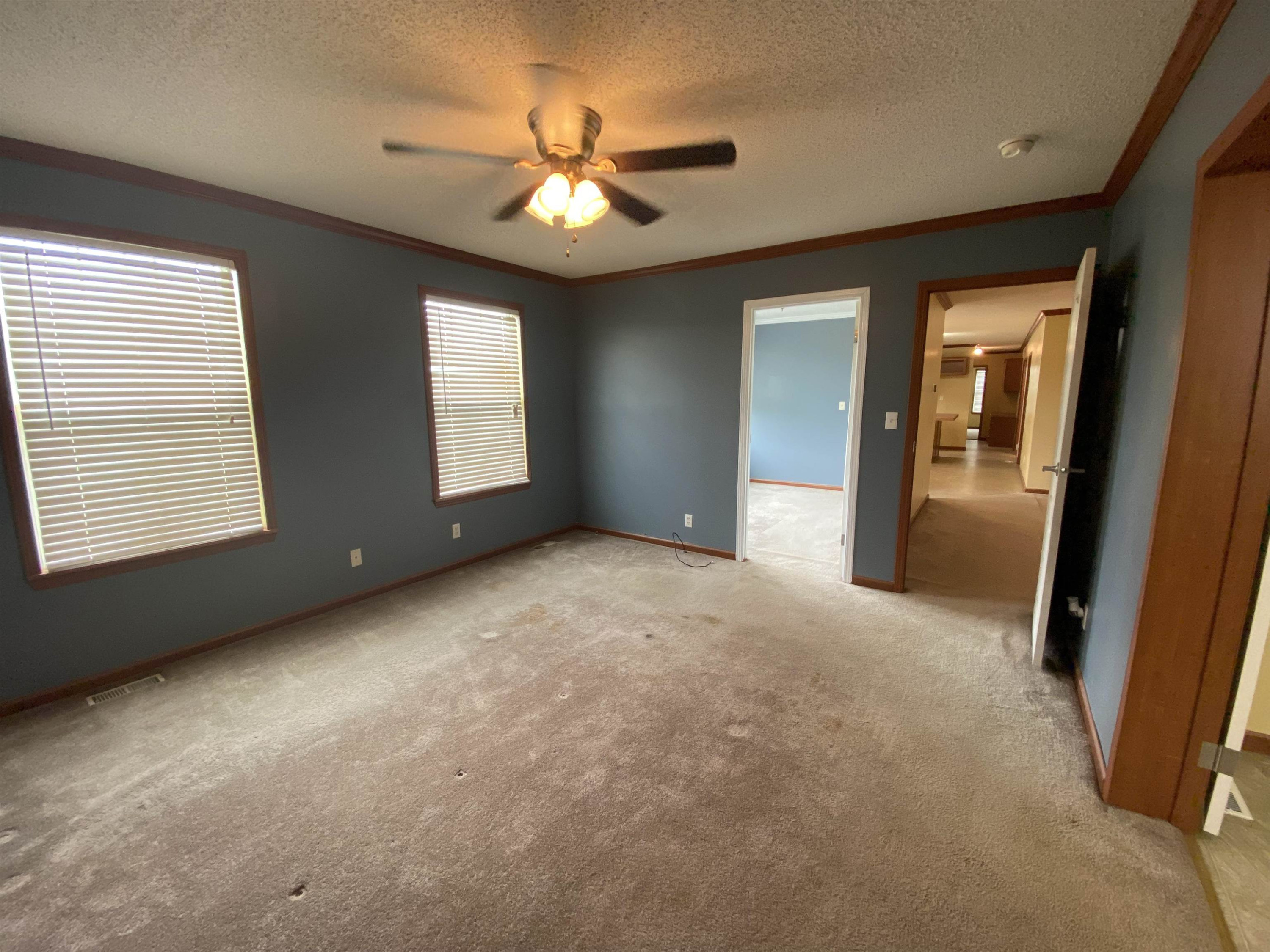 115 Bridgers Road Kenly, NC 27542 - Photo 15 of 30 a view of an empty room with chandelier fan and windows