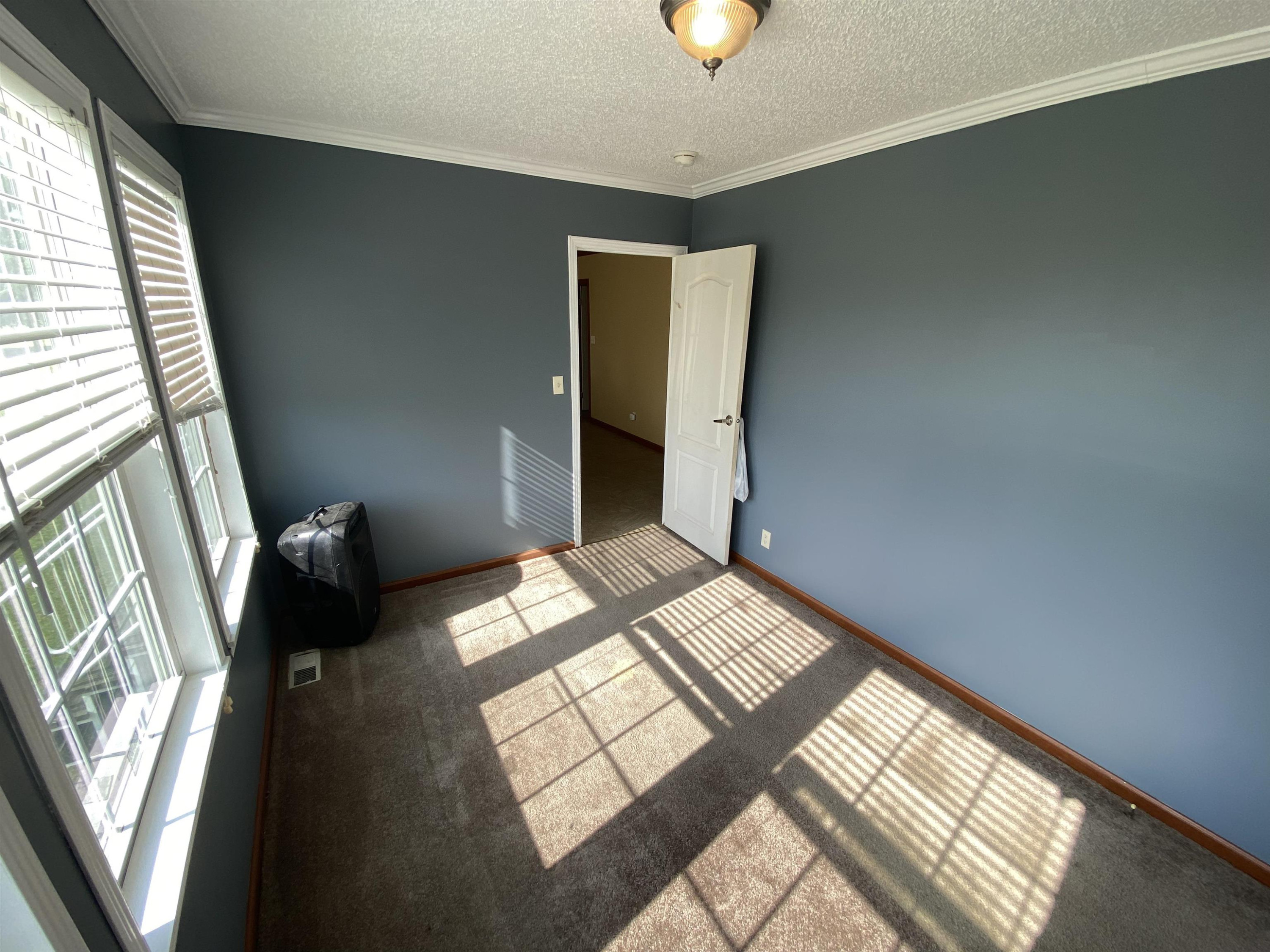 115 Bridgers Road Kenly, NC 27542 - Photo 19 of 30 a view of a bedroom with wooden floor and a window