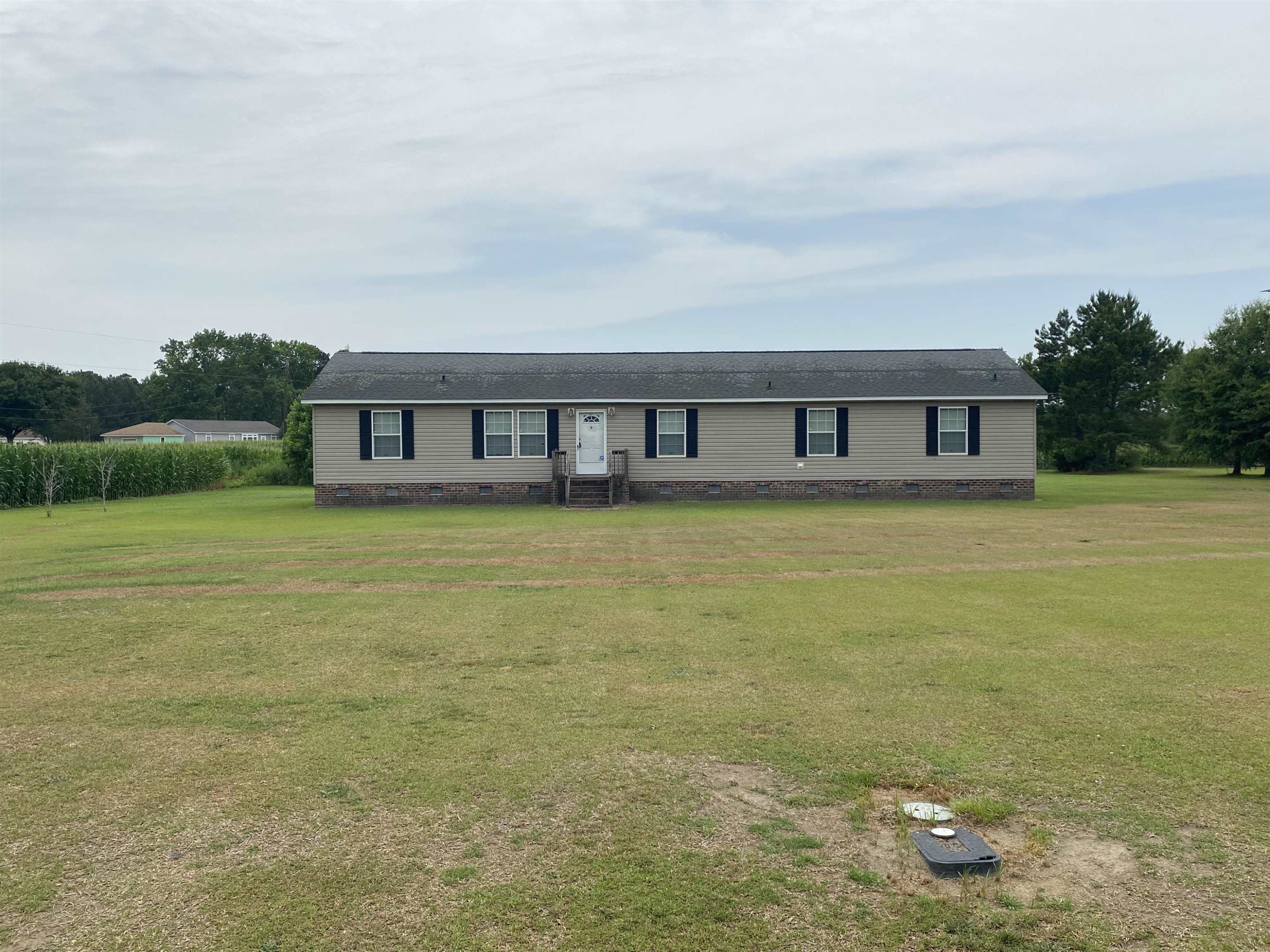 115 Bridgers Road Kenly, NC 27542 - Photo 2 of 30 a view of a room with floor to ceiling windows and lake view