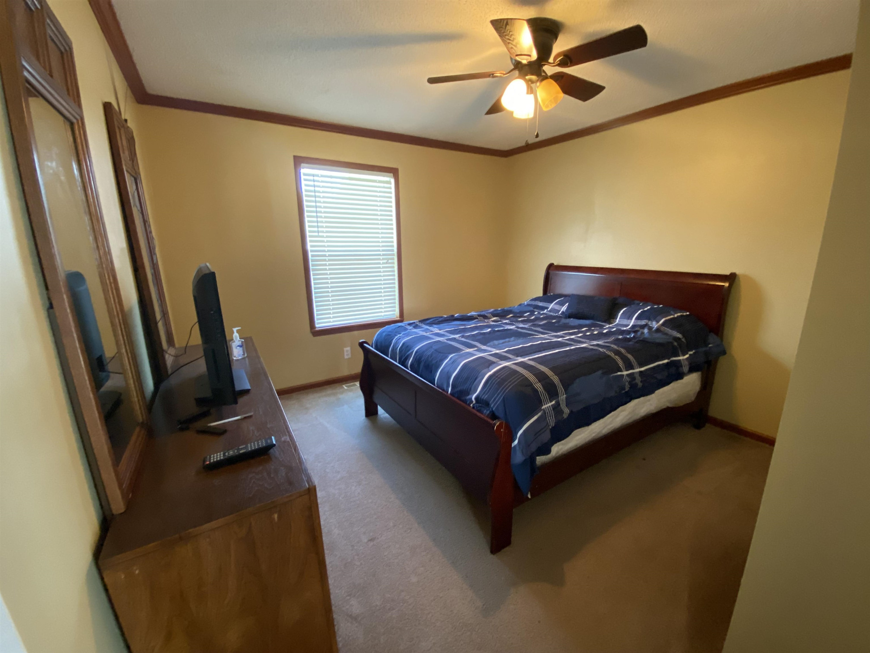 115 Bridgers Road Kenly, NC 27542 - Photo 21 of 30 a bedroom with a bed a window and a flat screen tv