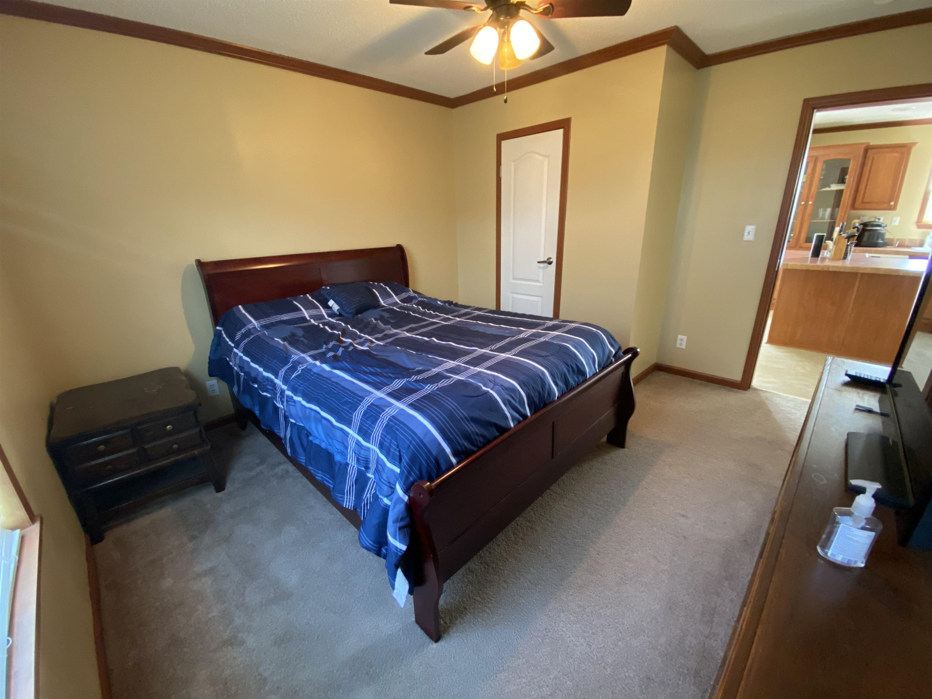 115 Bridgers Road Kenly, NC 27542 - Photo 22 of 30 a bedroom with a bed and a dresser next to a window