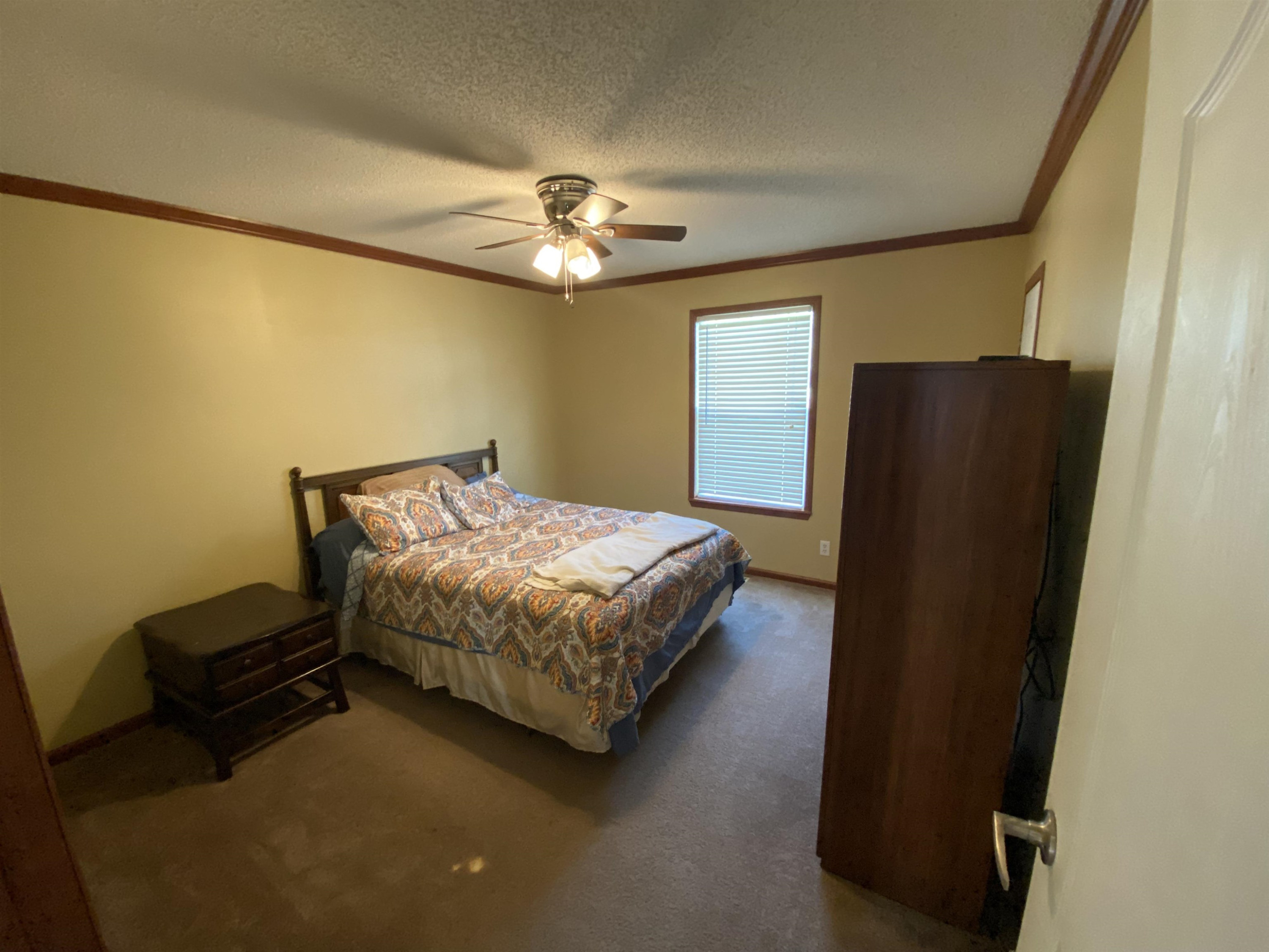 115 Bridgers Road Kenly, NC 27542 - Photo 24 of 30 a bedroom with a bed dresser and a window