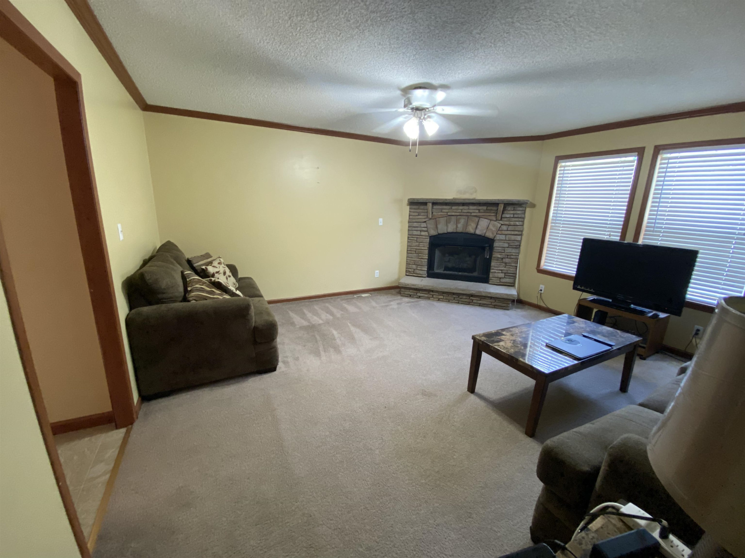 115 Bridgers Road Kenly, NC 27542 - Photo 27 of 30 a living room with furniture and a fireplace