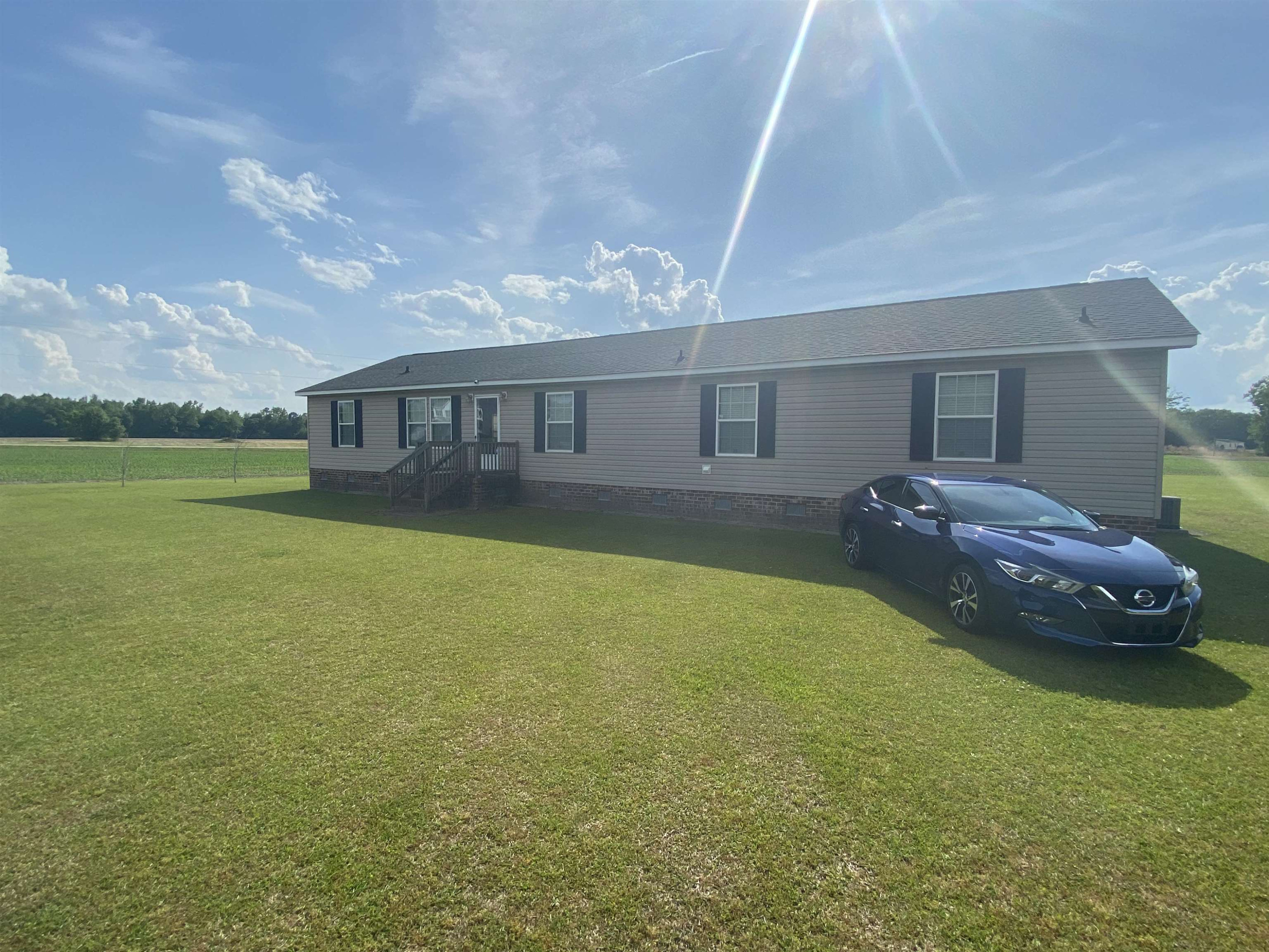 115 Bridgers Road Kenly, NC 27542 - Photo 3 of 30 a backyard of a house with table and chairs