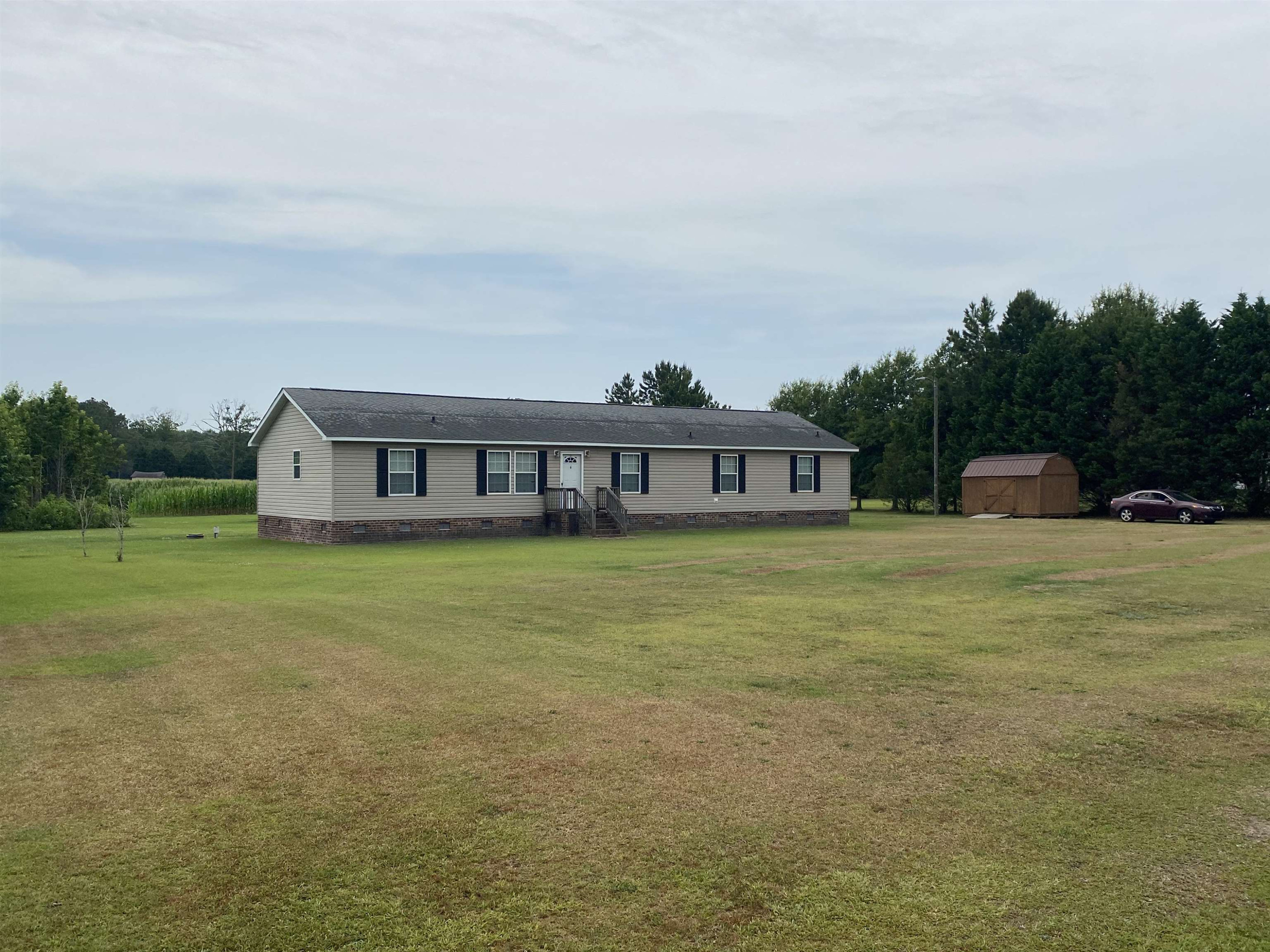 115 Bridgers Road Kenly, NC 27542 - Photo 4 of 30 a front view of a house with a yard table and chairs