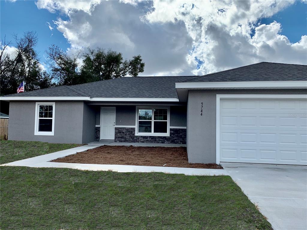 19955 Southwest 96th Lane Dunnellon, FL 34432 - Photo 1 of 1 a view of a yard in front of a house with a large tree