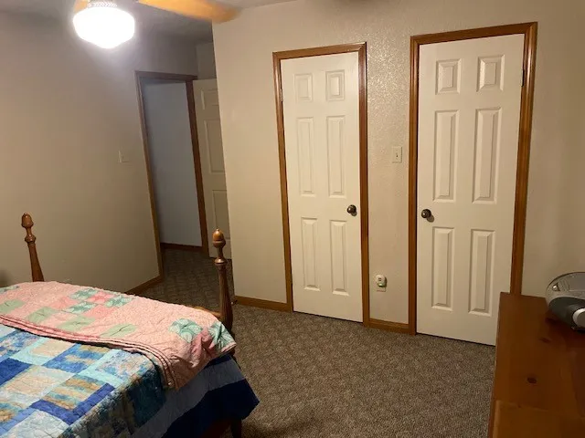 a bedroom with a bed and a mirror