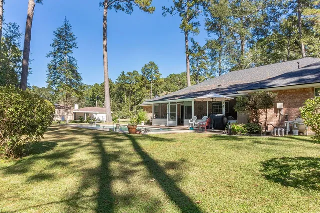a view of a house with swimming pool and sitting area