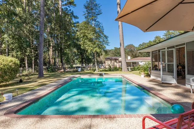a view of a swimming pool with sitting area