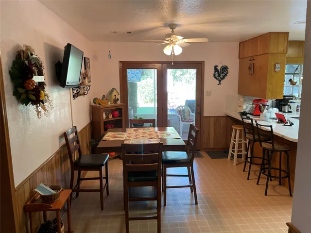 a view of a dining room with furniture and a chandelier