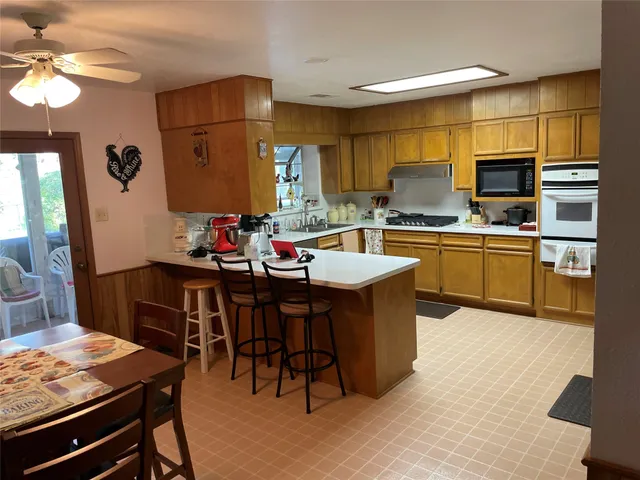 a kitchen with kitchen island granite countertop a sink counter top space and stainless steel appliances
