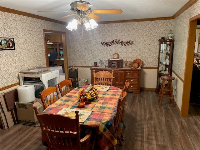 a view of a dining room with furniture and wooden floor