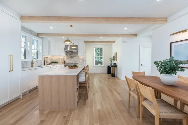 a dining room with furniture and wooden floor