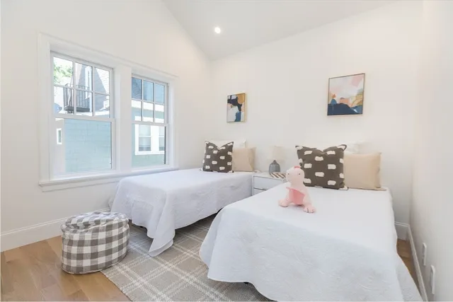 a bedroom with two beds and a couch