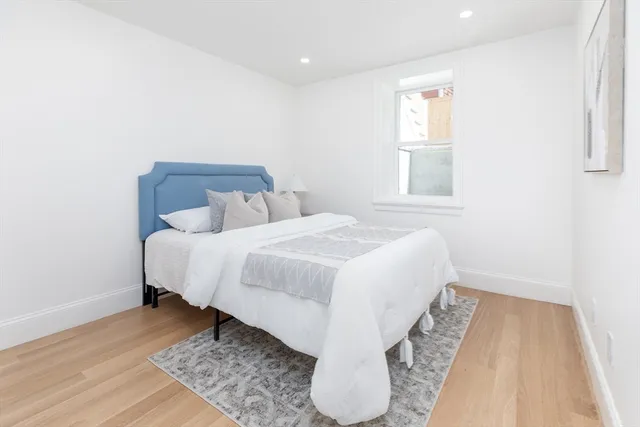 a bed room with a bed and a night stand