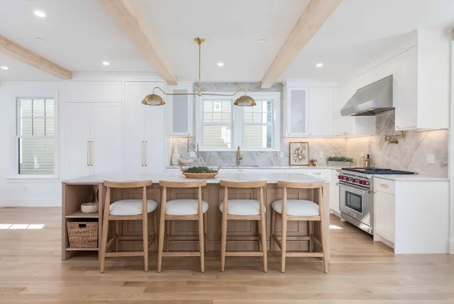 a large kitchen with a table and chairs