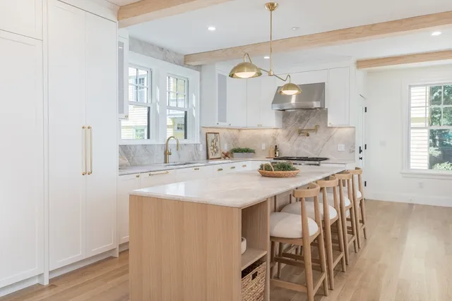 a kitchen with a table chairs sink and cabinets