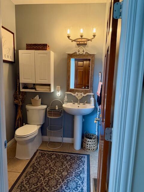 9261 Ruth Court St. John, IN 46373 - Photo 27 of 48 a bathroom with a toilet sink and mirror