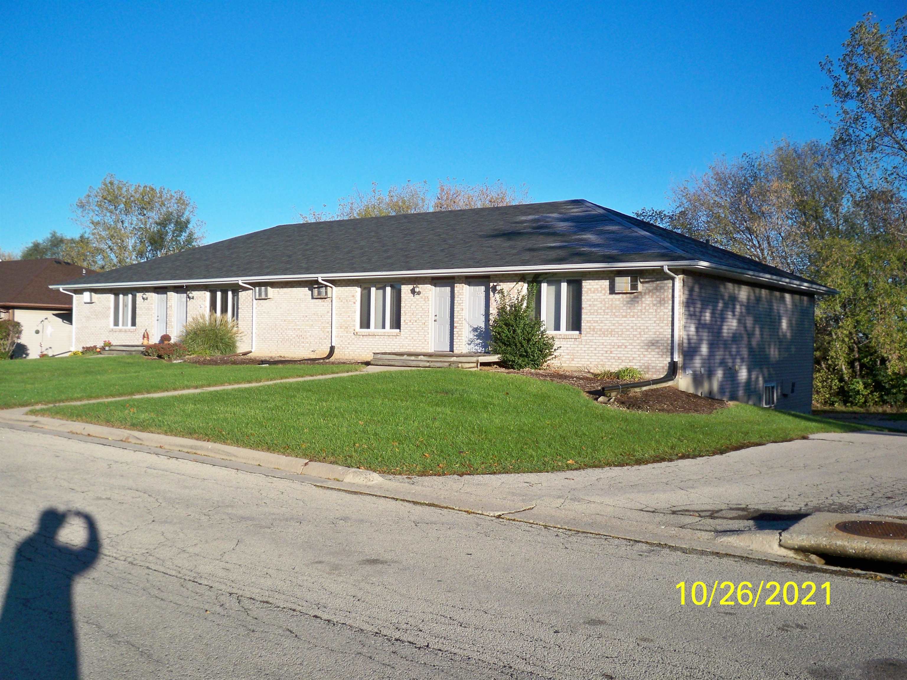 5672-8 Covey Ridge Trail Loves Park, IL 61111 - Photo 2 of 4 a front view of a house with a garden and yard