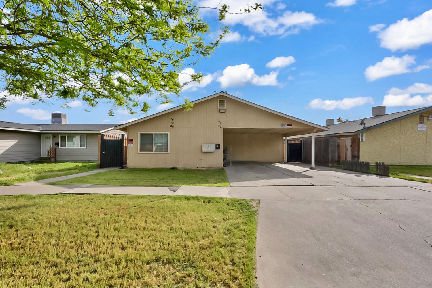 72 East 12th Street Merced, CA 95341 - Photo 1 of 13 a view of a yard in front of a house with a large tree