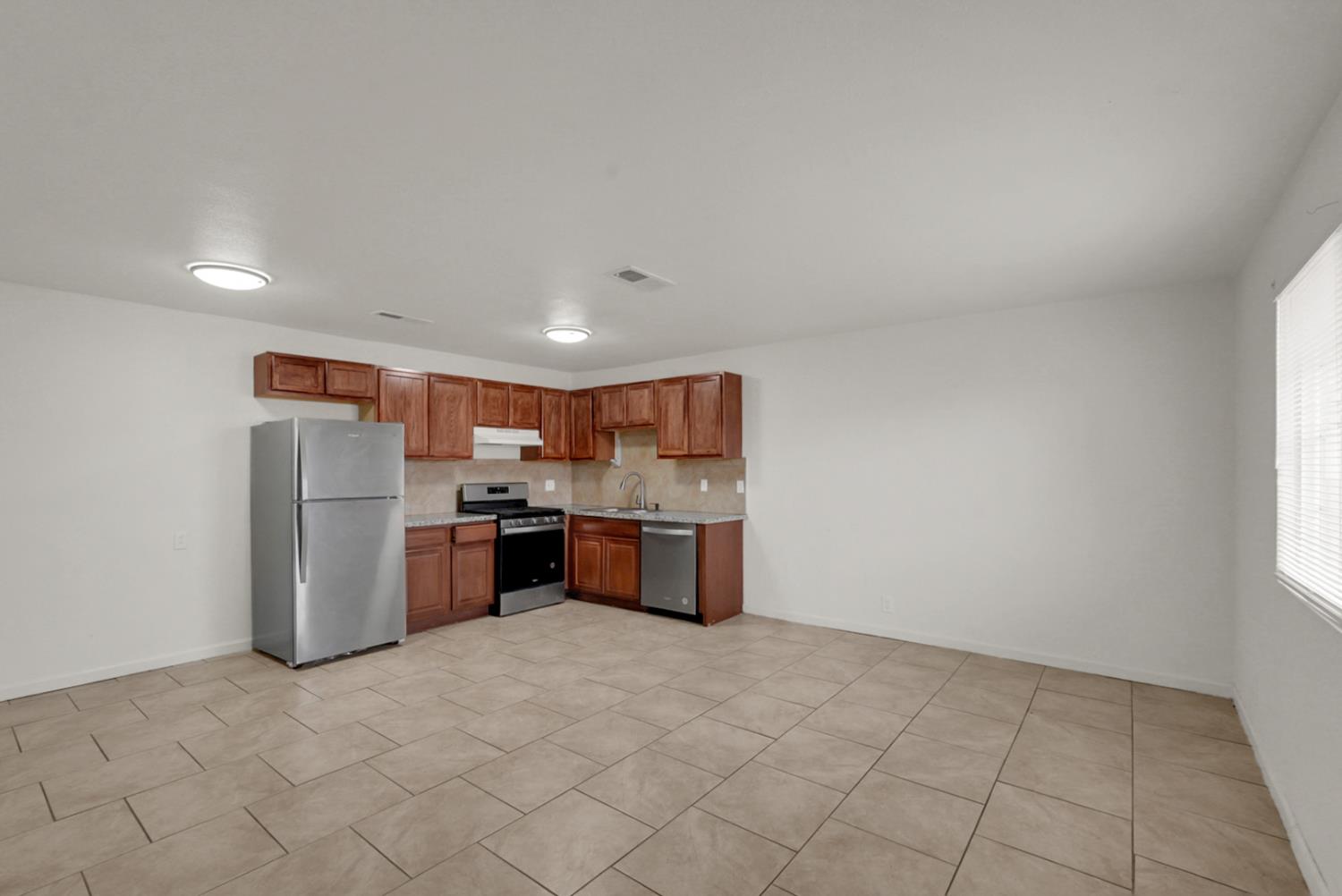 72 East 12th Street Merced, CA 95341 - Photo 12 of 13 a kitchen with a refrigerator and a sink