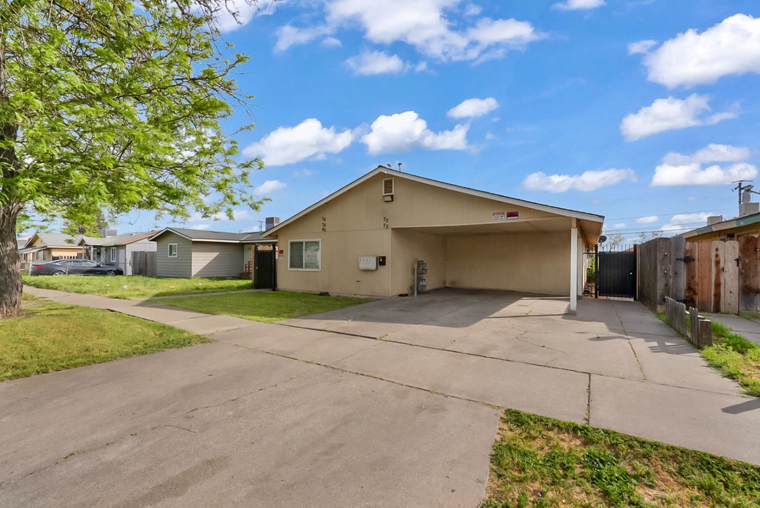 72 East 12th Street Merced, CA 95341 - Photo 2 of 13 a view of a house with a yard and large tree