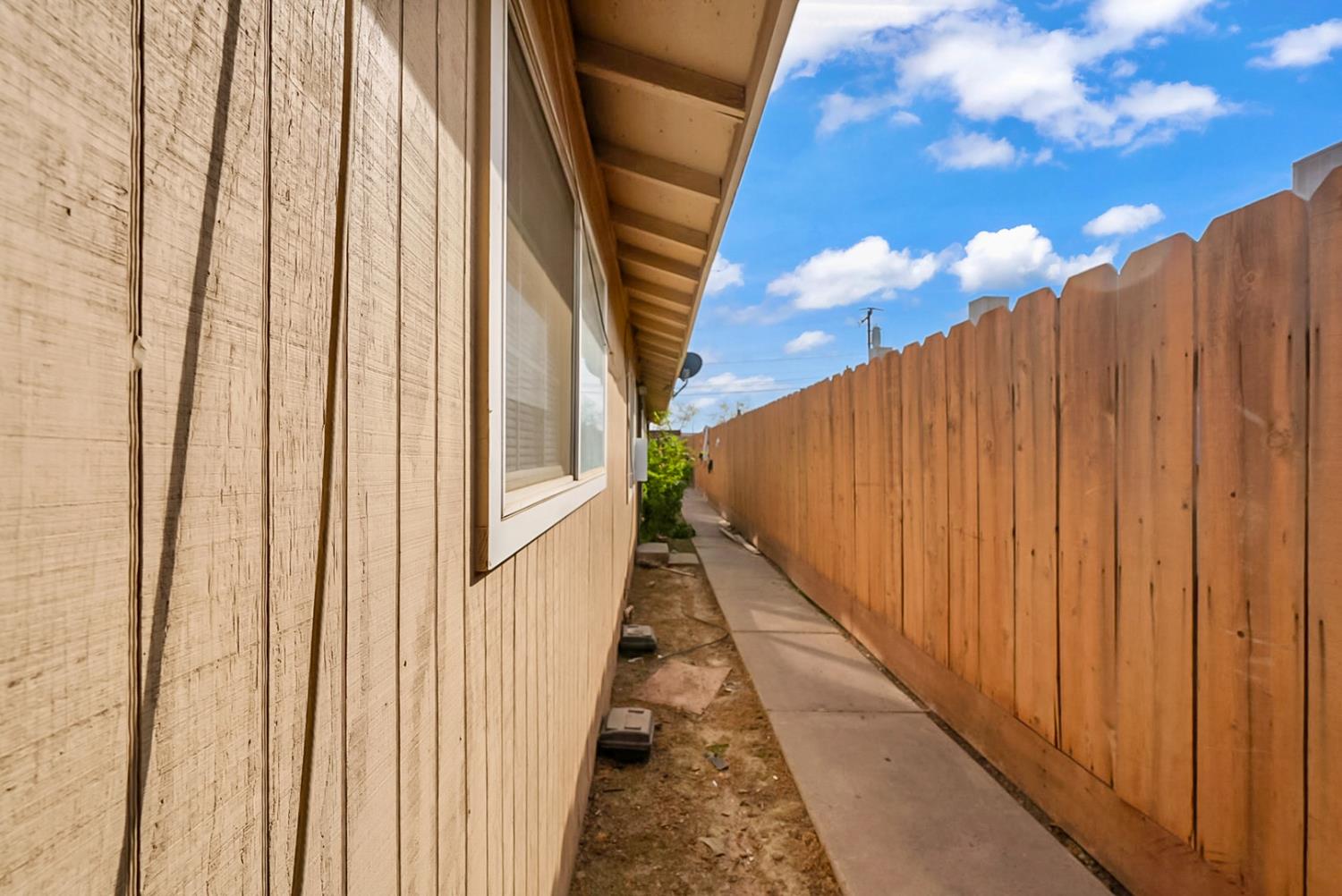 72 East 12th Street Merced, CA 95341 - Photo 3 of 13 a view of balcony with wooden floor and fence