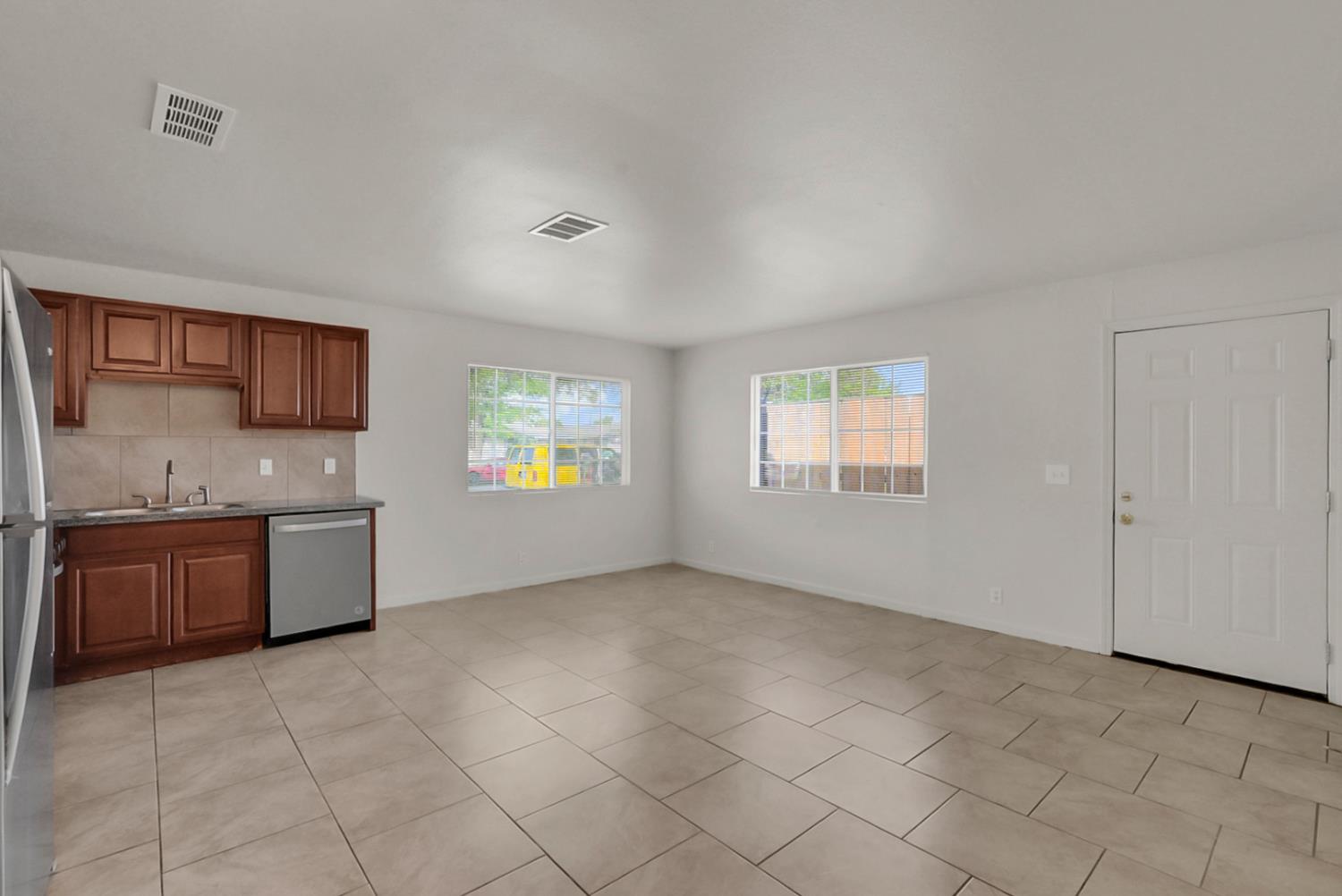 72 East 12th Street Merced, CA 95341 - Photo 8 of 13 a large kitchen with a stove a sink dishwasher and a refrigerator