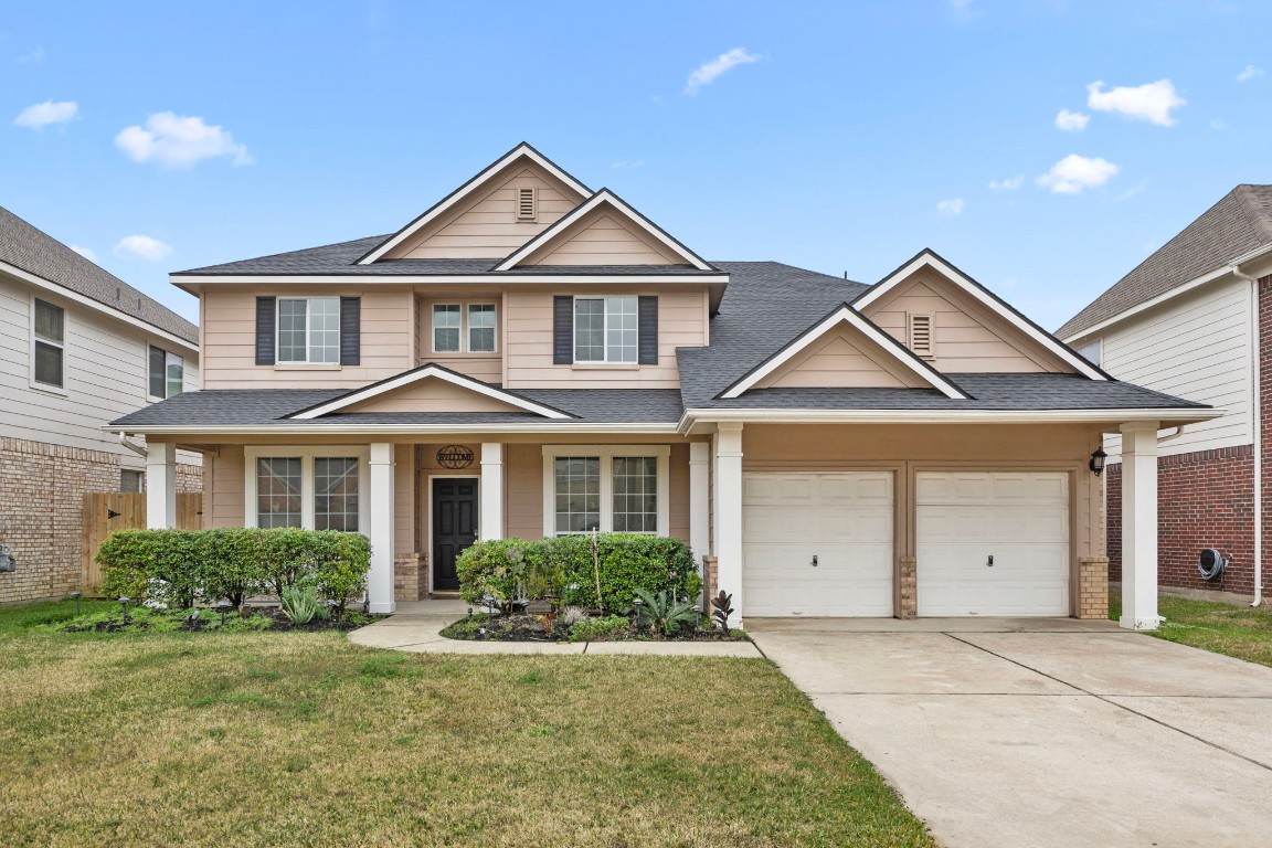 a front view of a house with a yard and garage