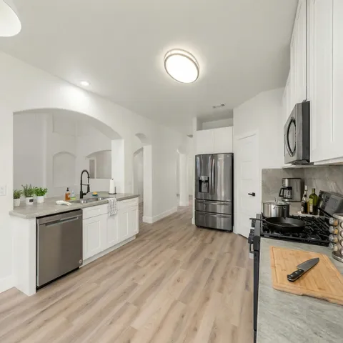a view of empty room with wooden floor and fireplace