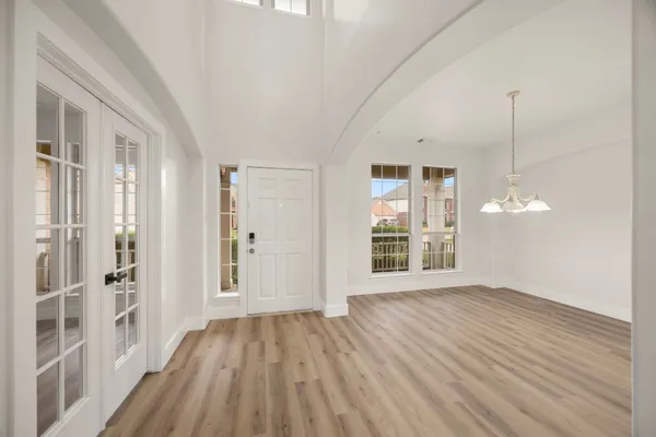 a view of a room with wooden floor and a window