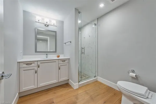 a spacious bathroom with a shower a sink and mirror