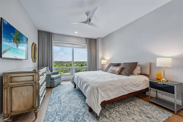 a bedroom with a large bed and a window