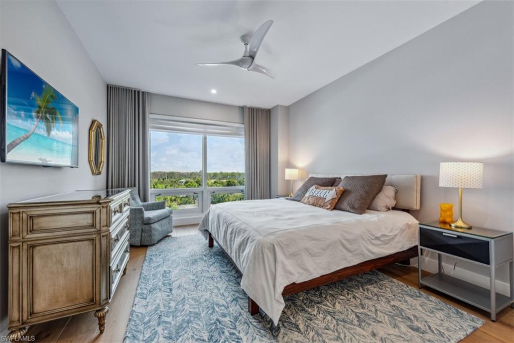 13915 Old Coast Road, Unit 504 Naples, FL 34110 - Photo 12 of 41 a bedroom with a large bed and a window