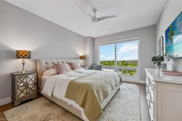 a bedroom with a large bed and a chandelier