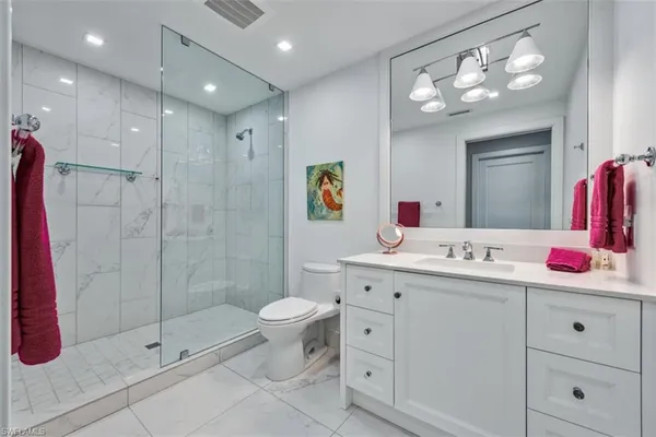 a bathroom with a sink vanity and mirror