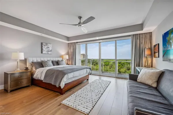 a bedroom with a large bed and a couch